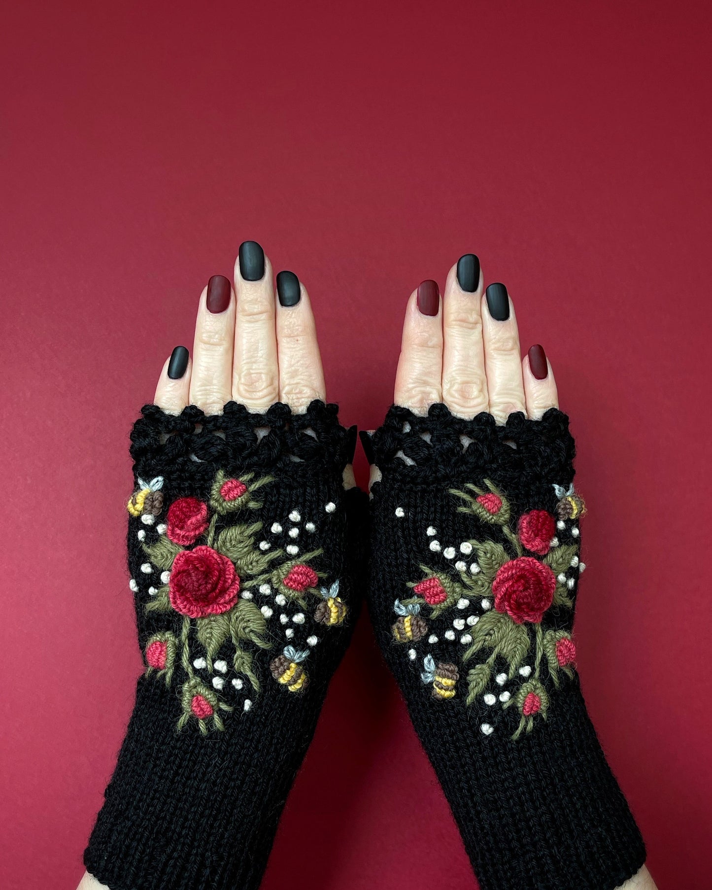 Black hand knitted gloves with embroidered red roses and bees