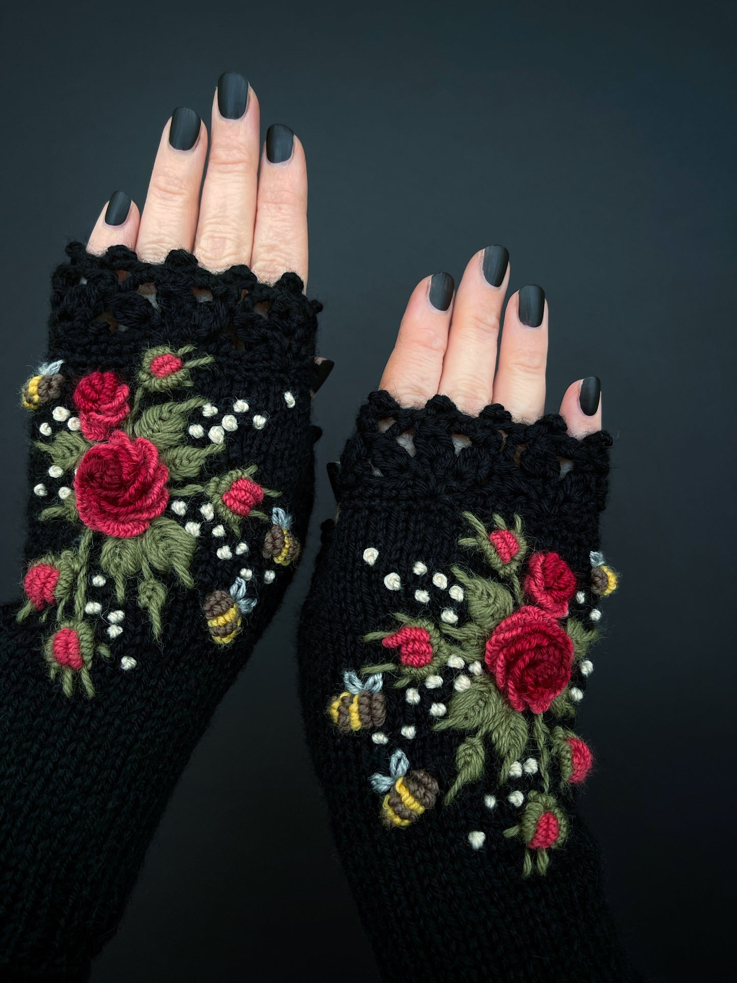 Black hand knitted gloves with embroidered red roses and bees