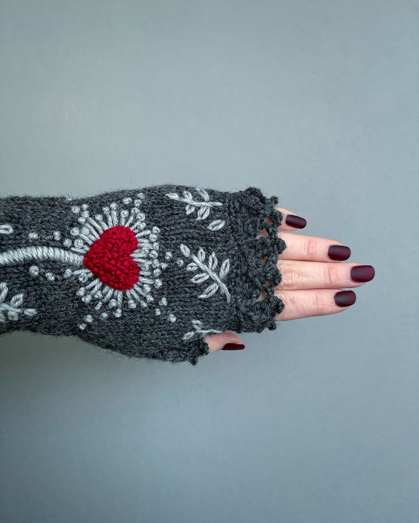 Gray gloves with hearts and leaves