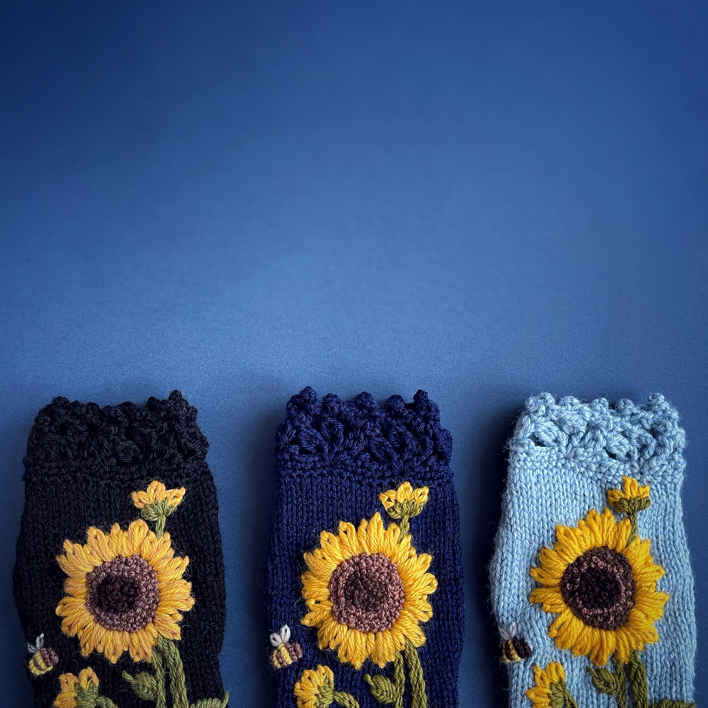 Navy blue fingerless gloves with sunflowers and bees