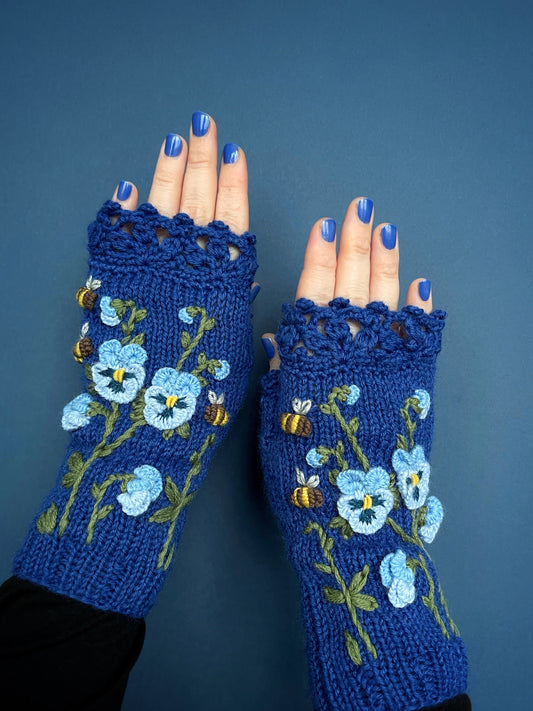 Blue gloves with embroidered pansy flowers and bees