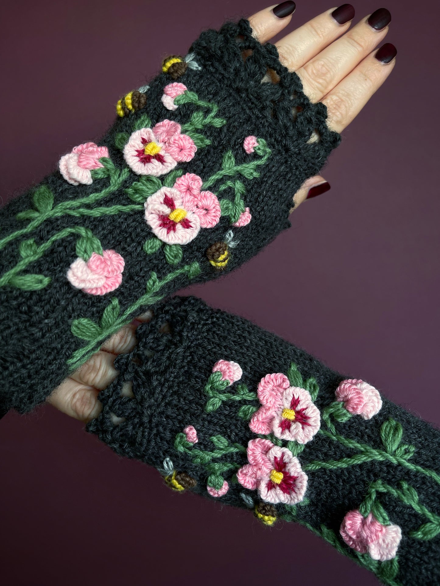 Dark gray hand knitted gloves with pink pansy flowers embroidery