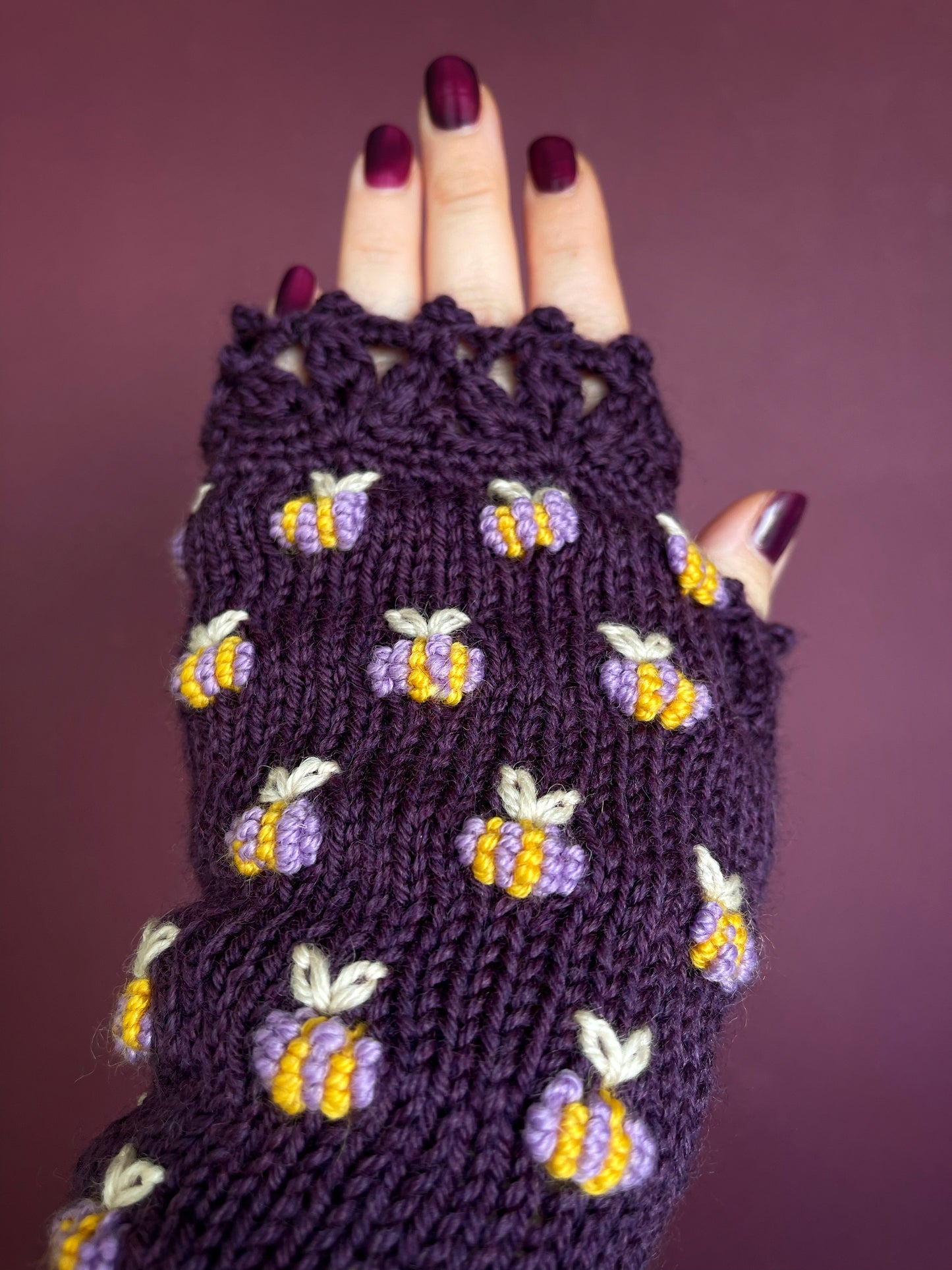 Hand knitted violet fingerless gloves with lilac bees embroidery