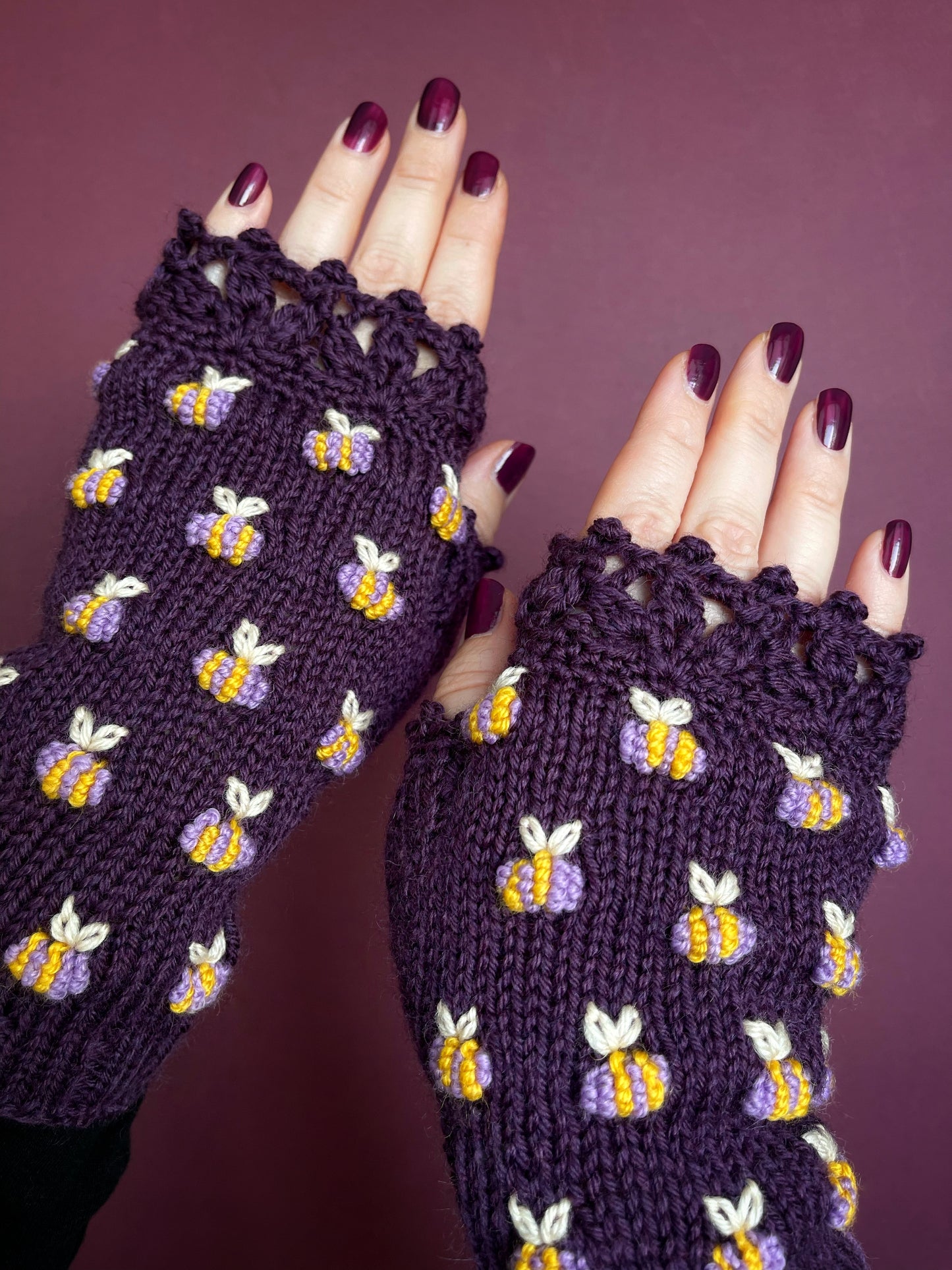 Hand knitted violet fingerless gloves with lilac bees embroidery