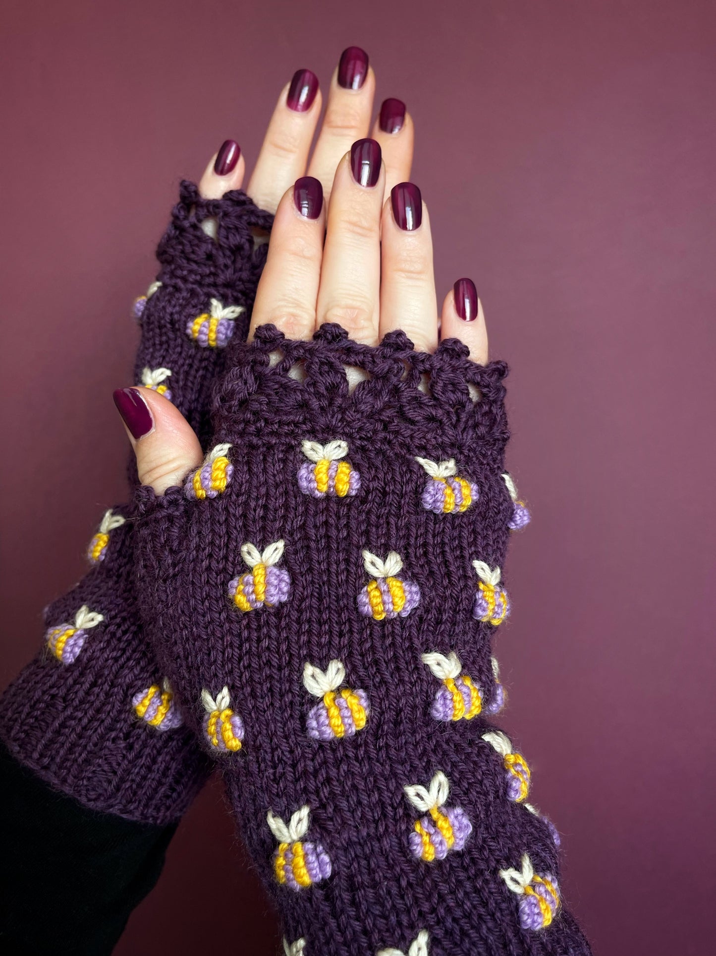 Hand knitted violet fingerless gloves with lilac bees embroidery