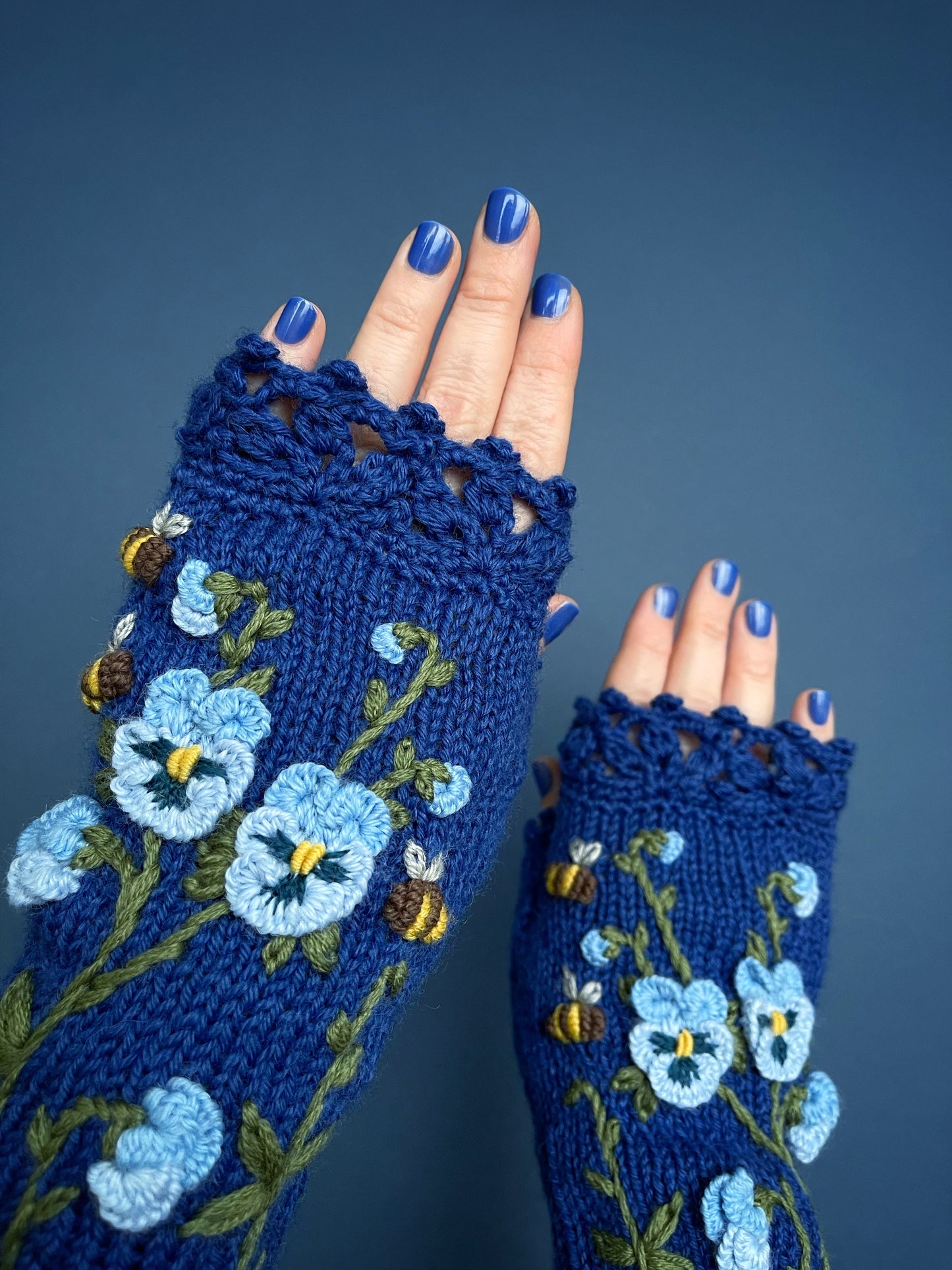 Blue embroidered gloves with pansy flowers and bees