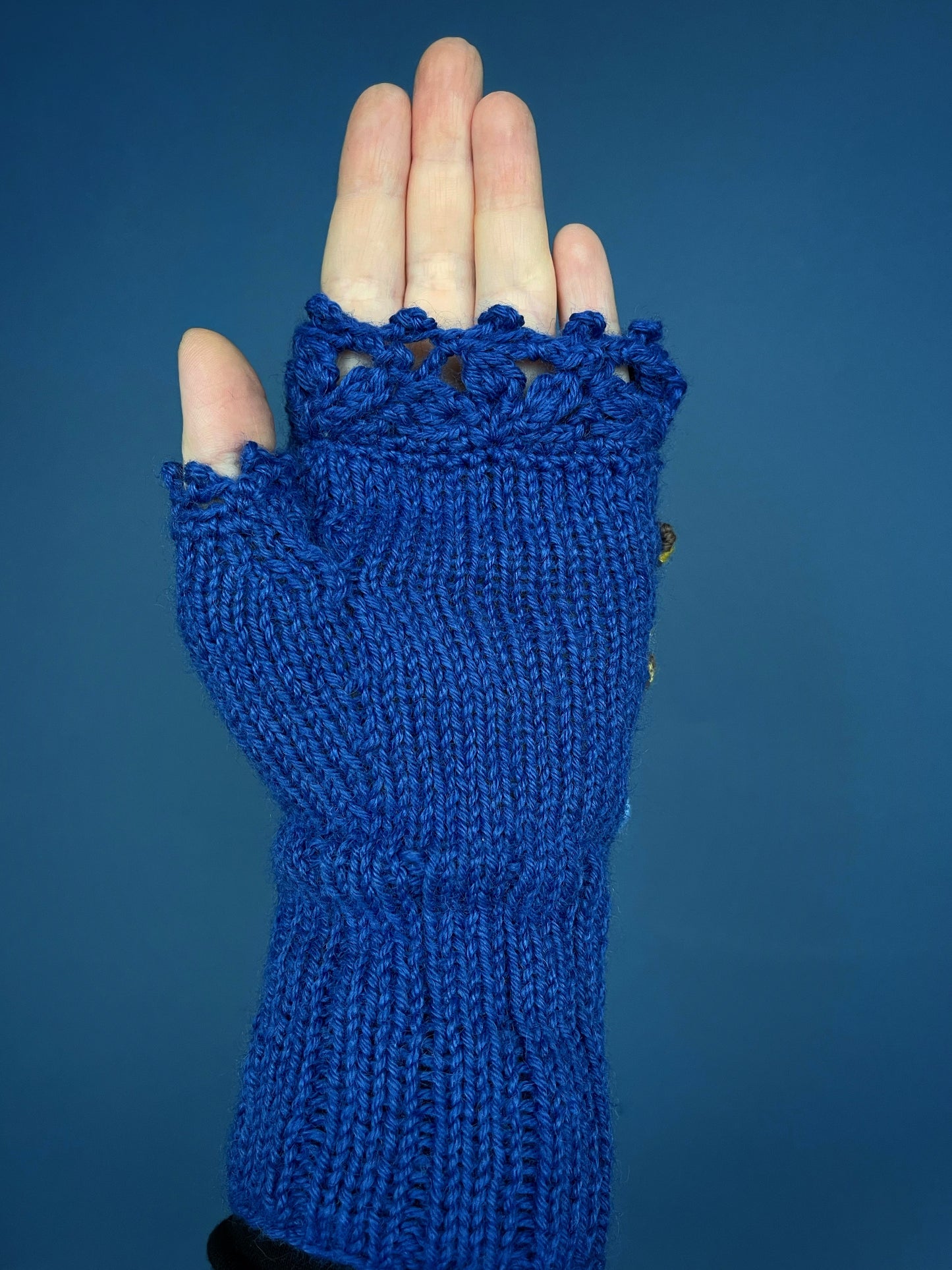 Blue embroidered gloves with pansy flowers and bees