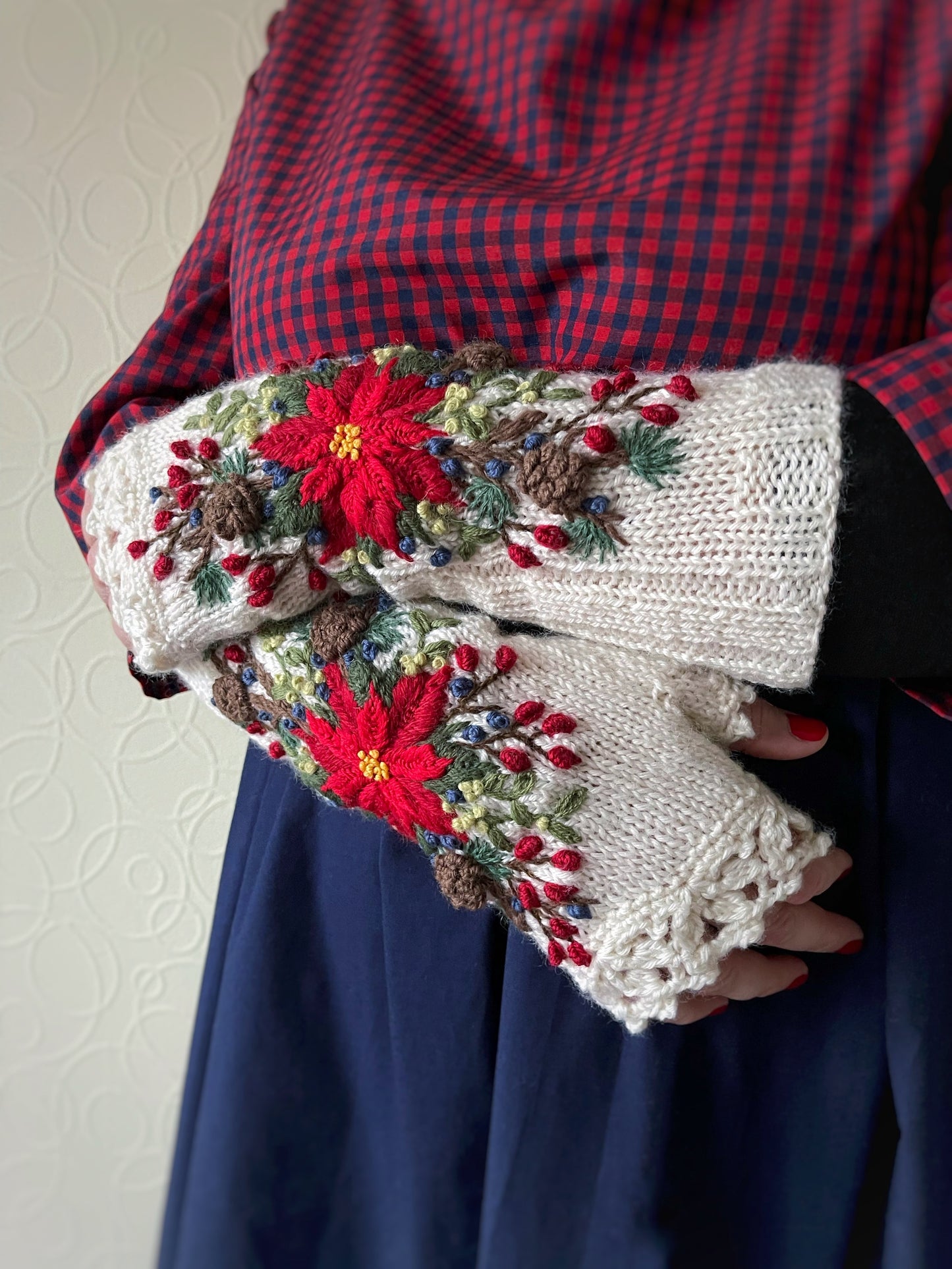 White embroidered gloves with poinsettia flowers, larch cones, rose hips and mistletoe