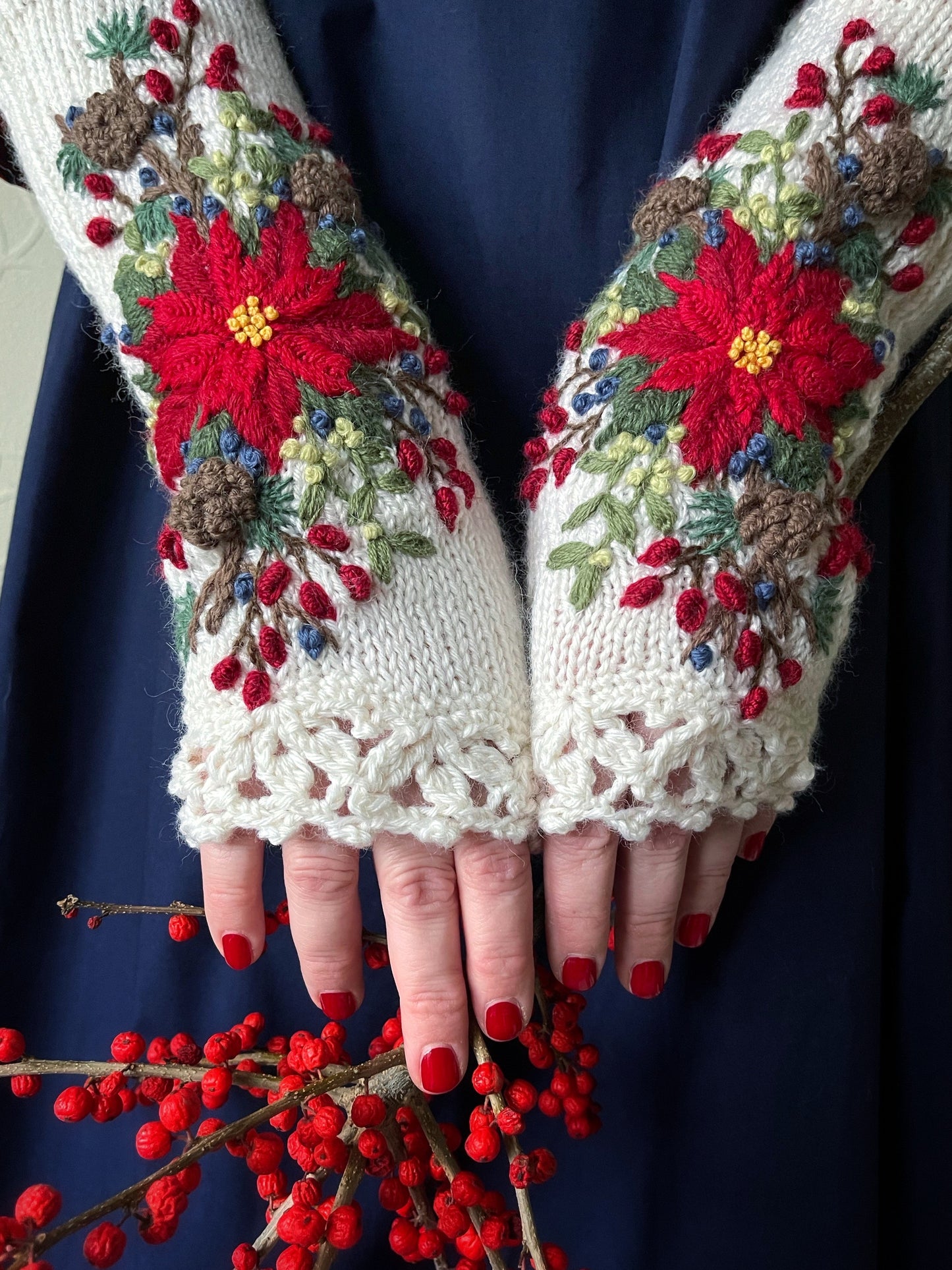 White embroidered gloves with poinsettia flowers, larch cones, rose hips and mistletoe