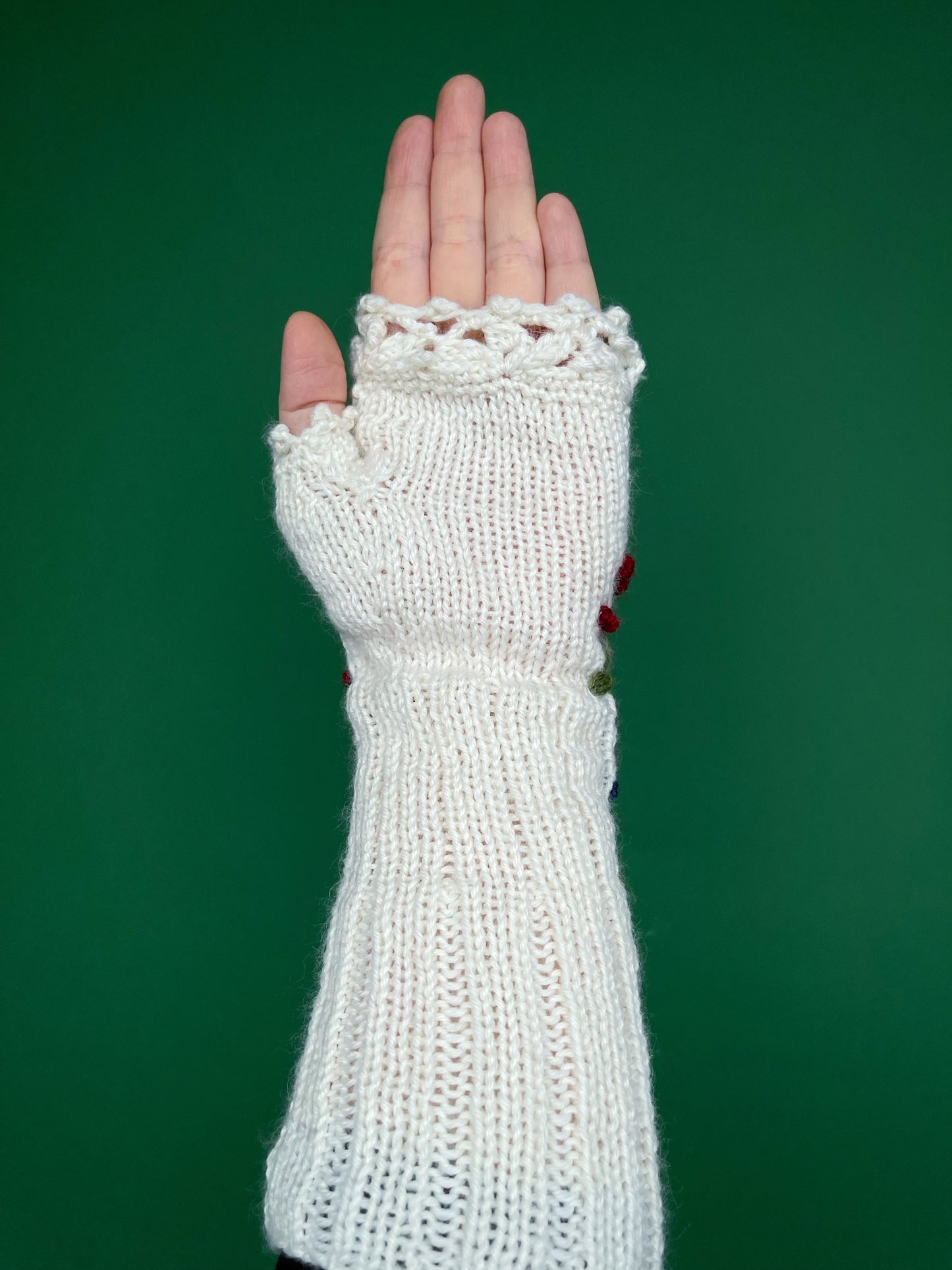 White embroidered gloves with poinsettia flowers, larch cones, rose hips and mistletoe