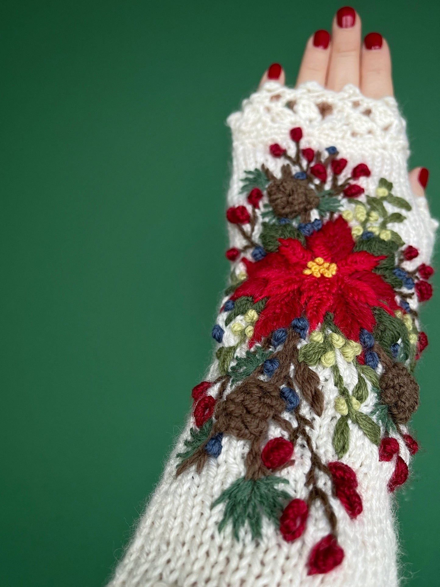 White embroidered gloves with poinsettia flowers, larch cones, rose hips and mistletoe