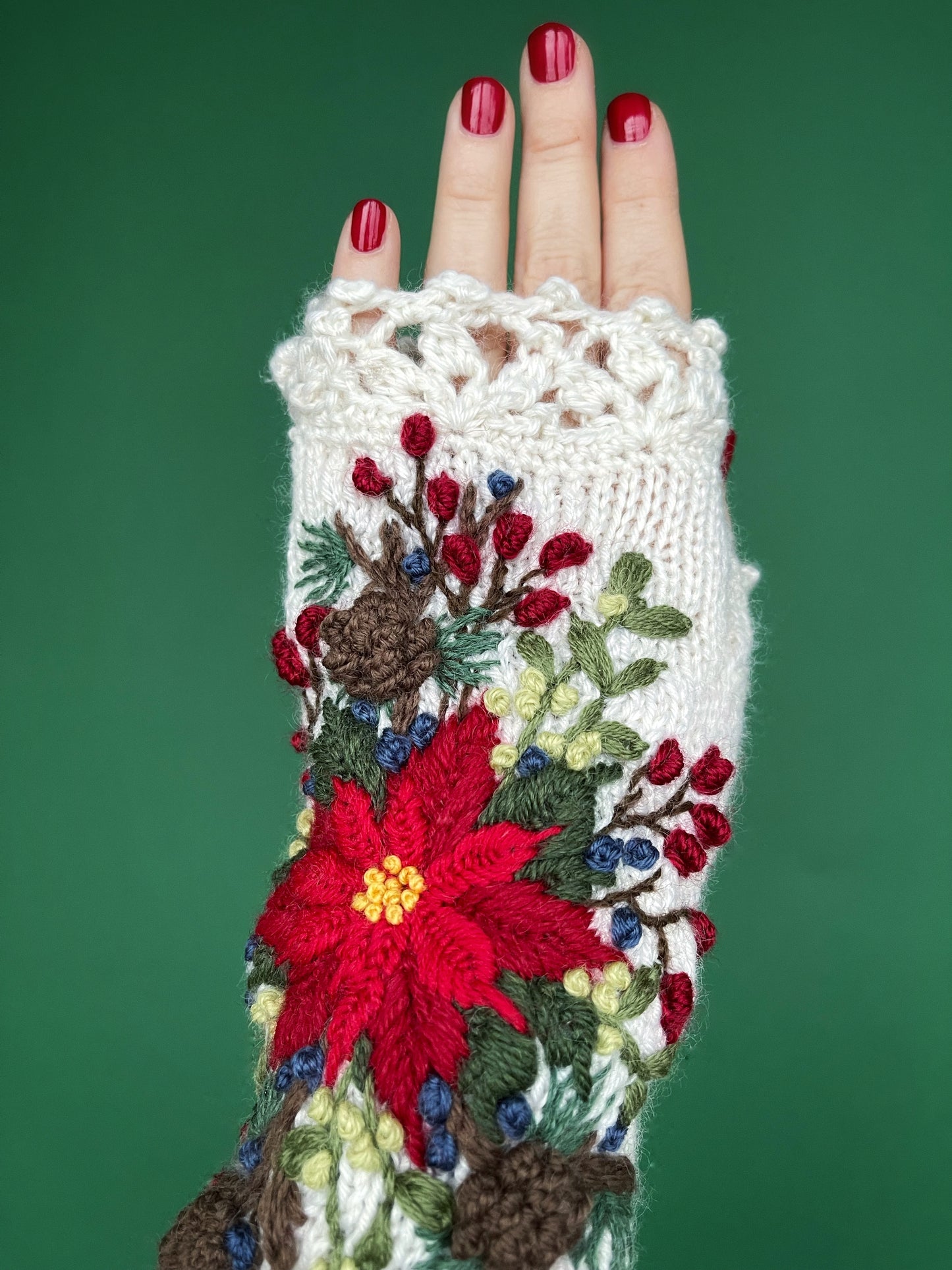 White embroidered gloves with poinsettia flowers, larch cones, rose hips and mistletoe