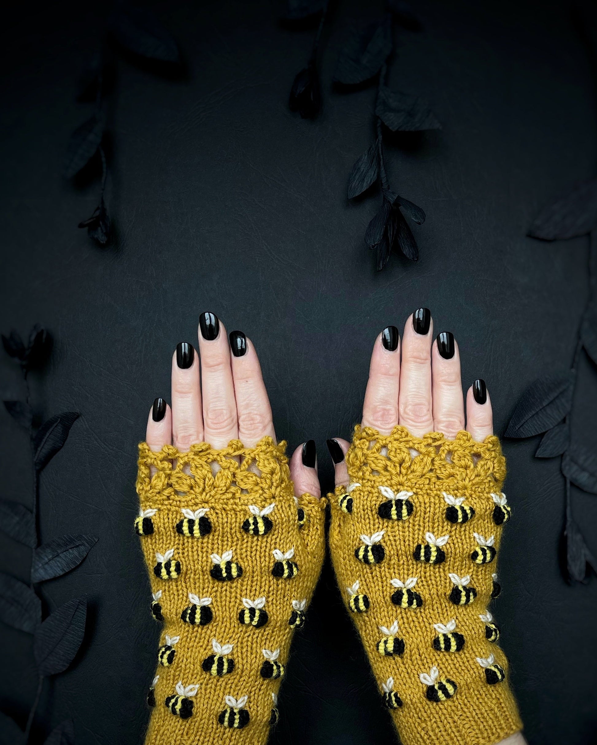 Fingerless mustard gloves with bees