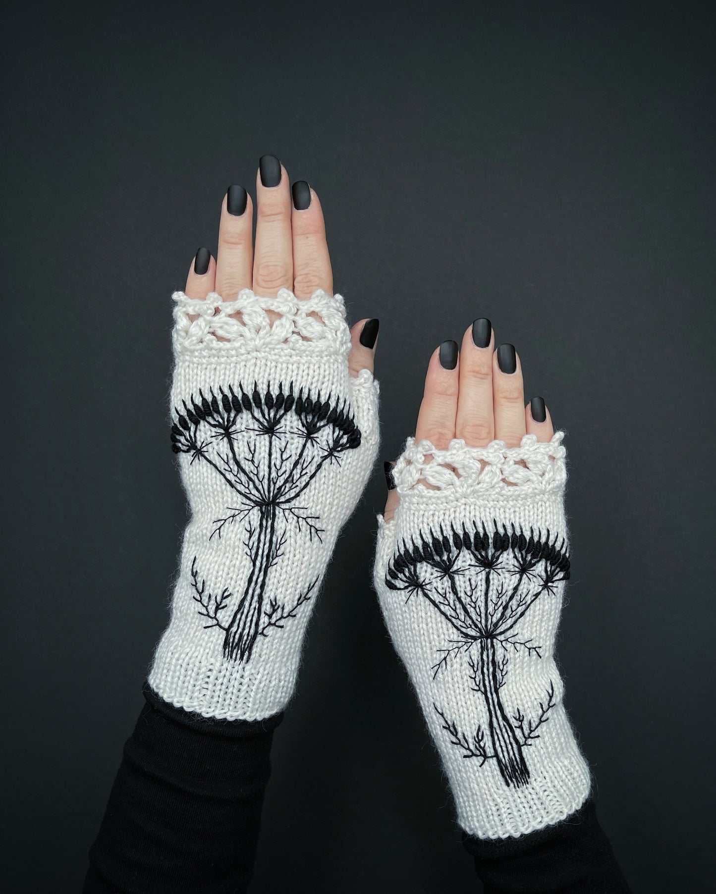 White gloves with embroidered black flower